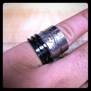 2 silver one black rings
